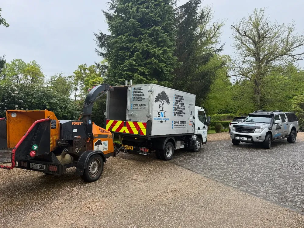 SNL Tree Surgeons branded truck and woodchipper on a job in Central Scotland